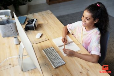 A student girl is actively taking part in the online class.