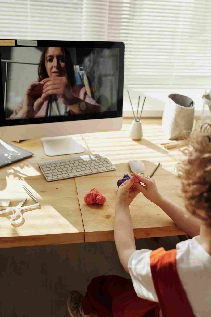 a kid is studying online and teacher is teaching with the help of online whiteboard